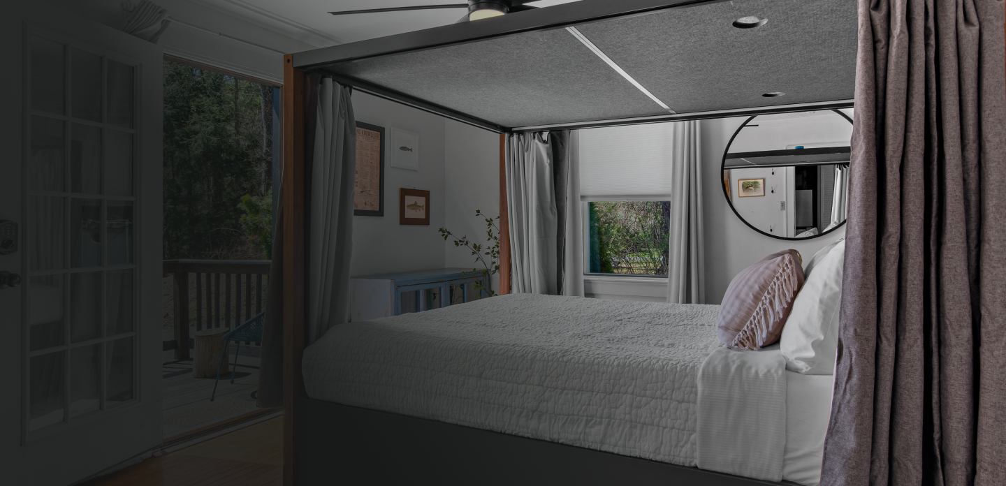 Elevate Your Sleep - Canopy Sleep in Walnut with white bedding in a room with a view